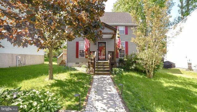 a front view of a house with a yard and fountain