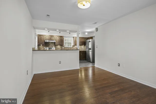 a kitchen with granite countertop a sink and cabinets
