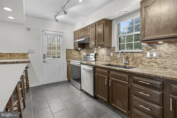 a kitchen with a stove a sink and a refrigerator