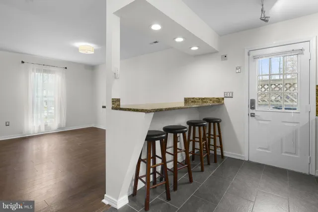 a view of kitchen with furniture and wooden floor