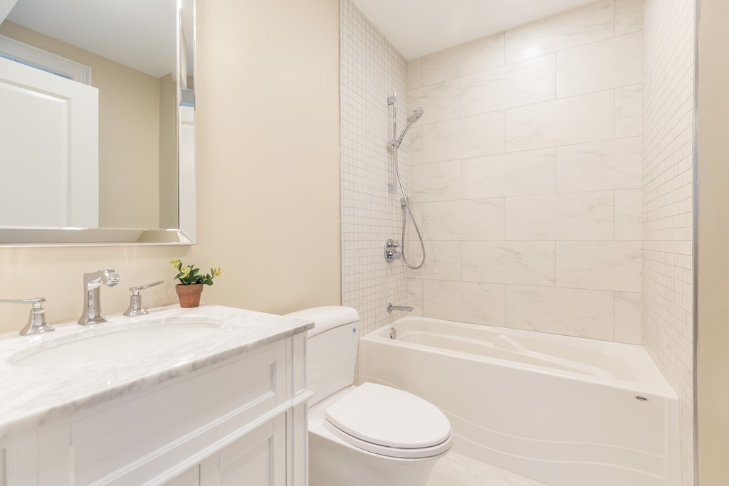 31 Summit Avenue, Unit 1 Brookline, MA 02446 - Photo 11 of 18 a bathroom with a sink a toilet and a bathtub