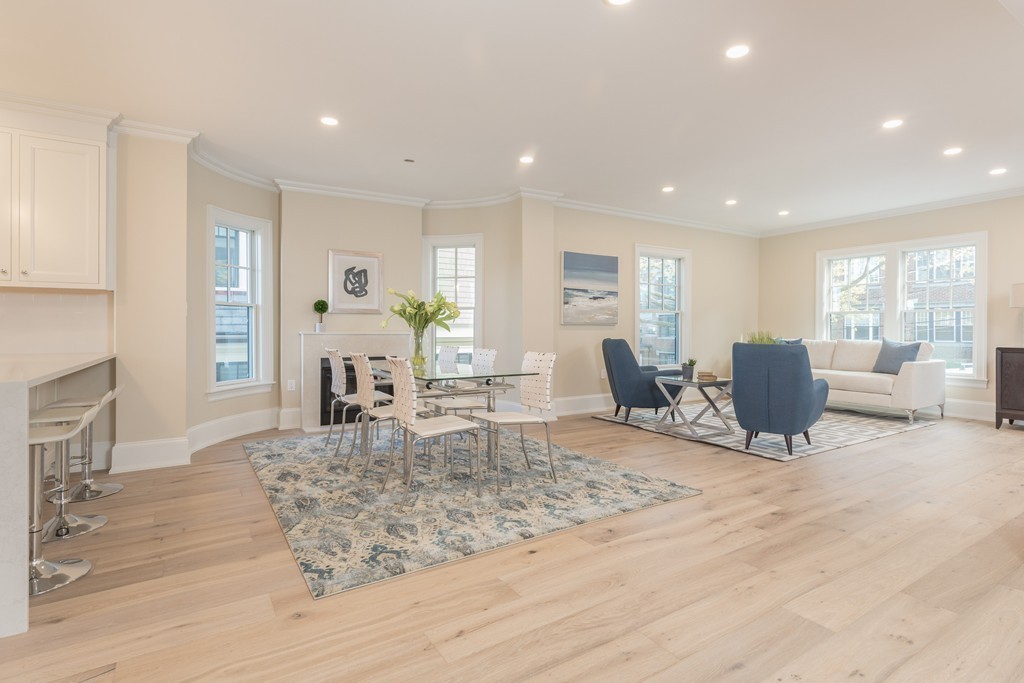 31 Summit Avenue, Unit 1 Brookline, MA 02446 - Photo 7 of 18 a living room with furniture a large window and a table