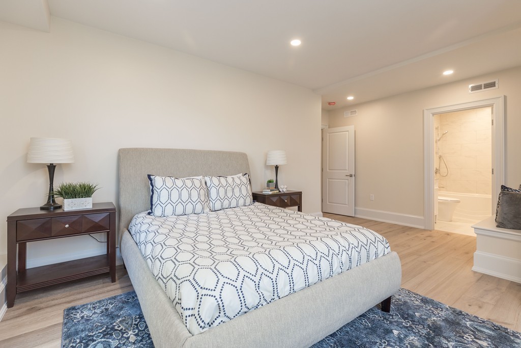 31 Summit Avenue, Unit 1 Brookline, MA 02446 - Photo 10 of 18 a bedroom with a large bed and a couch