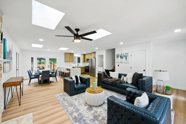 a living room with furniture and kitchen view