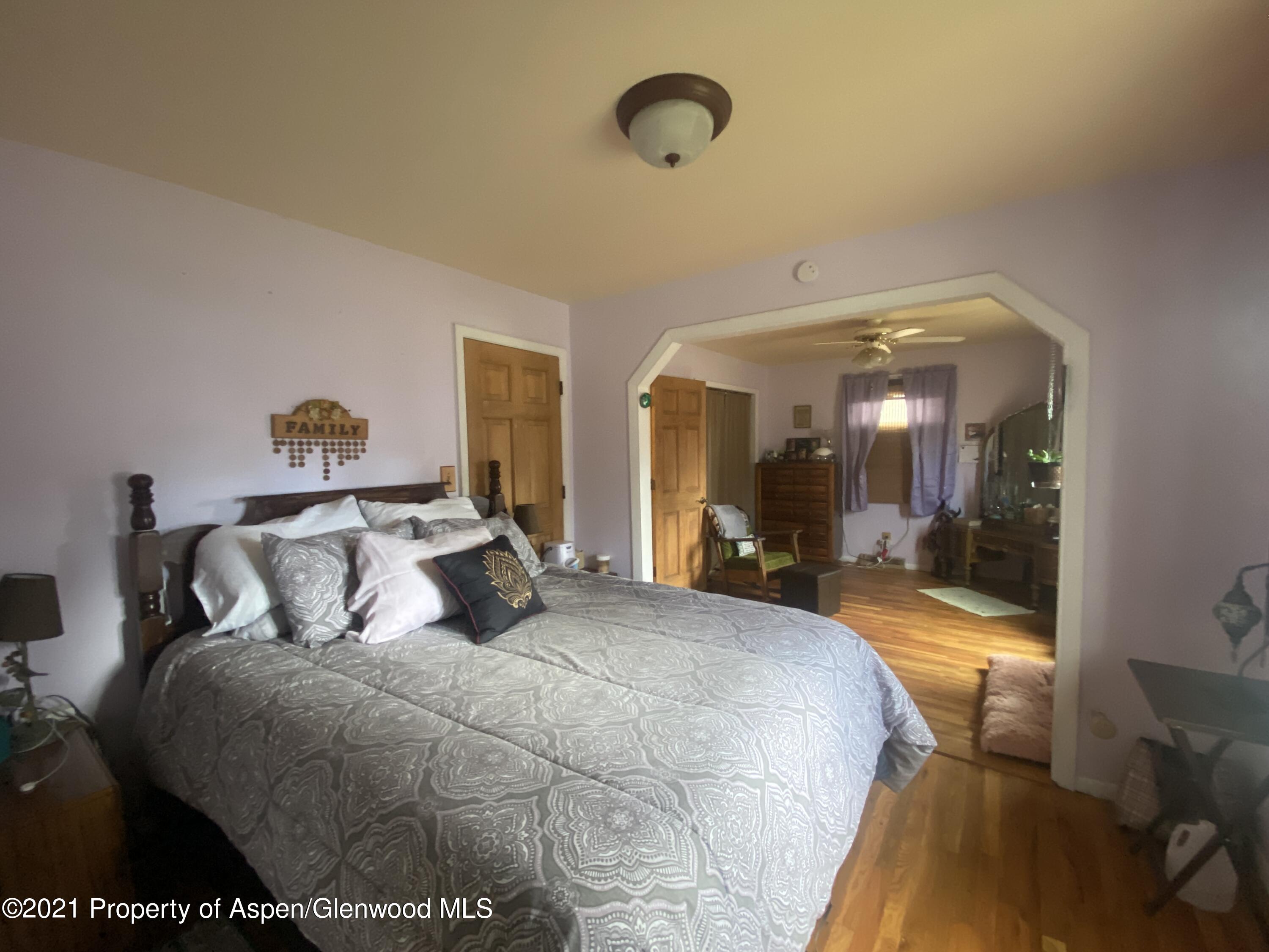404 Hutton Avenue Rifle, CO 81650 - Photo 12 of 27 a bedroom with a bed and glass door