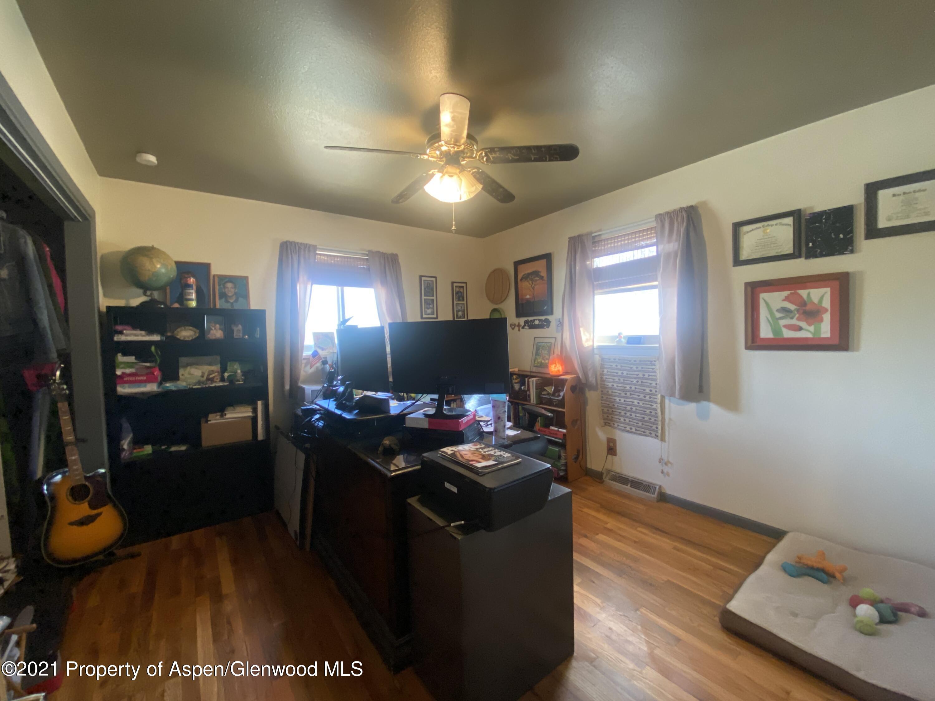 404 Hutton Avenue Rifle, CO 81650 - Photo 15 of 27 a living room with furniture and a flat screen tv