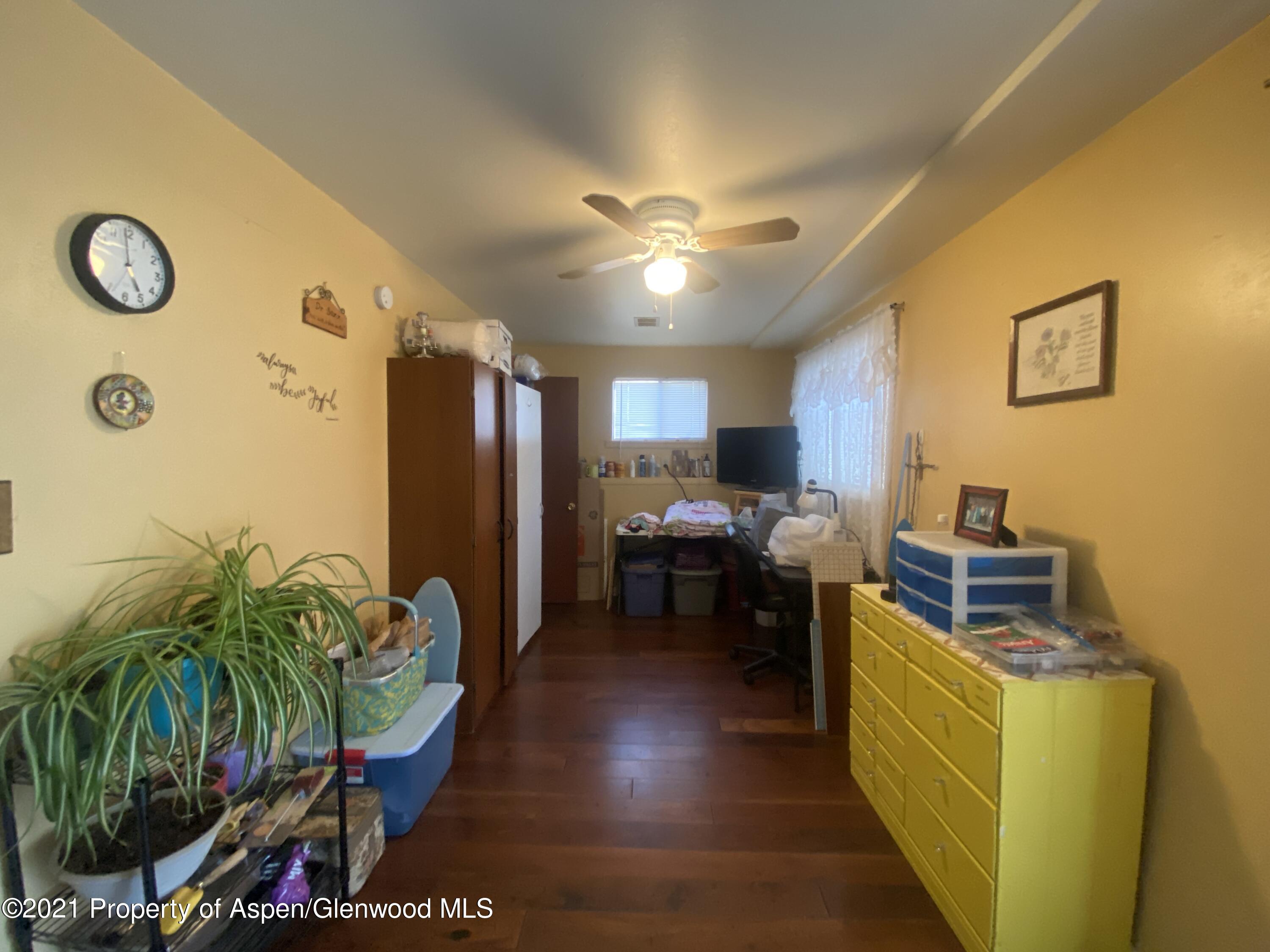 404 Hutton Avenue Rifle, CO 81650 - Photo 18 of 27 a living room with furniture and a potted plant