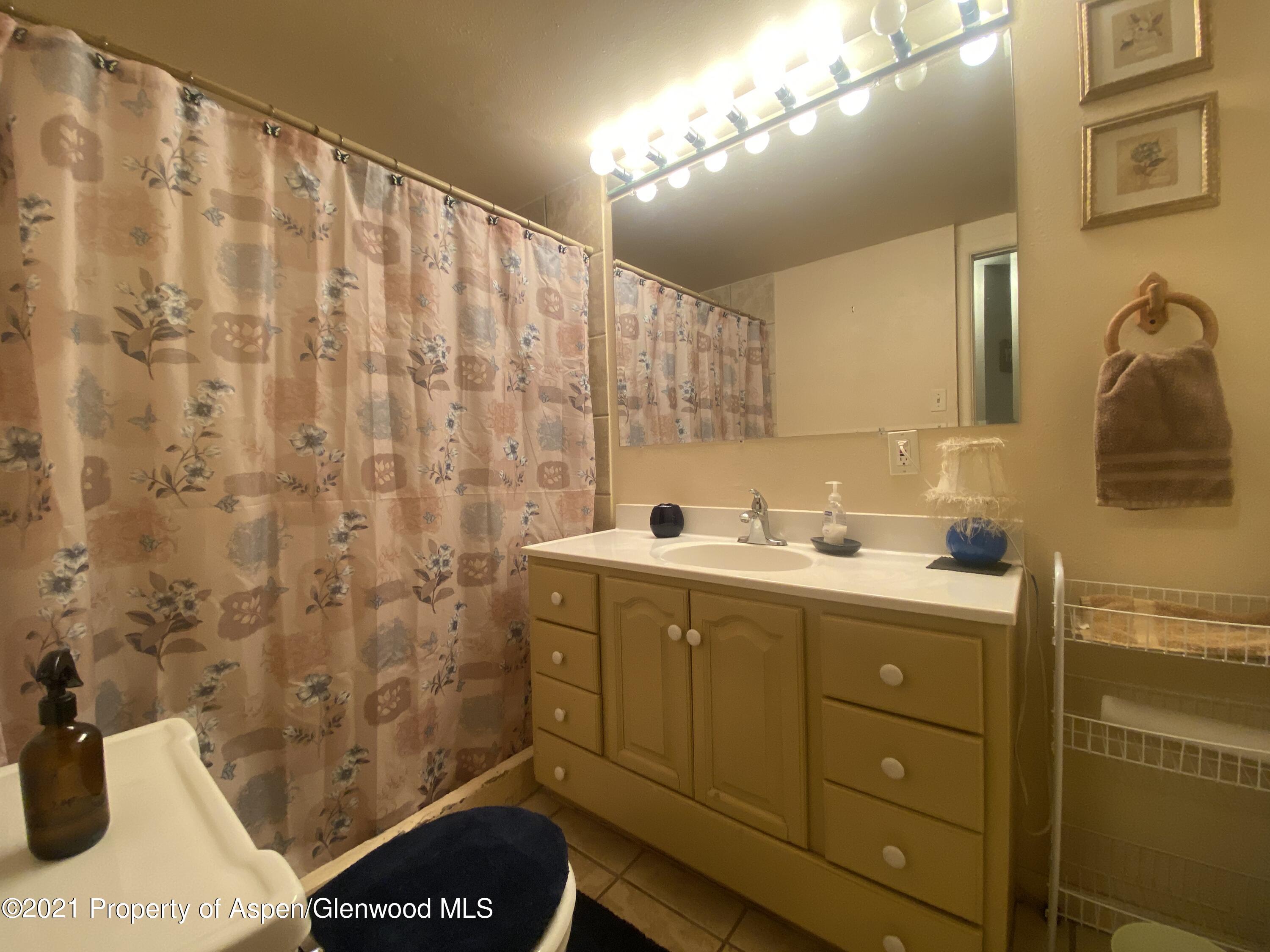 404 Hutton Avenue Rifle, CO 81650 - Photo 20 of 27 a bathroom with a sink and mirror