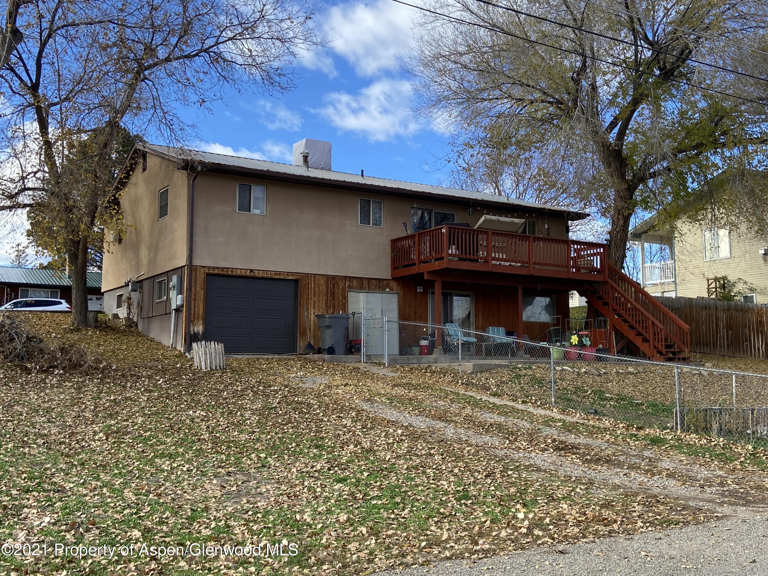 404 Hutton Avenue Rifle, CO 81650 - Photo 26 of 27 a view of a house with a patio and a yard