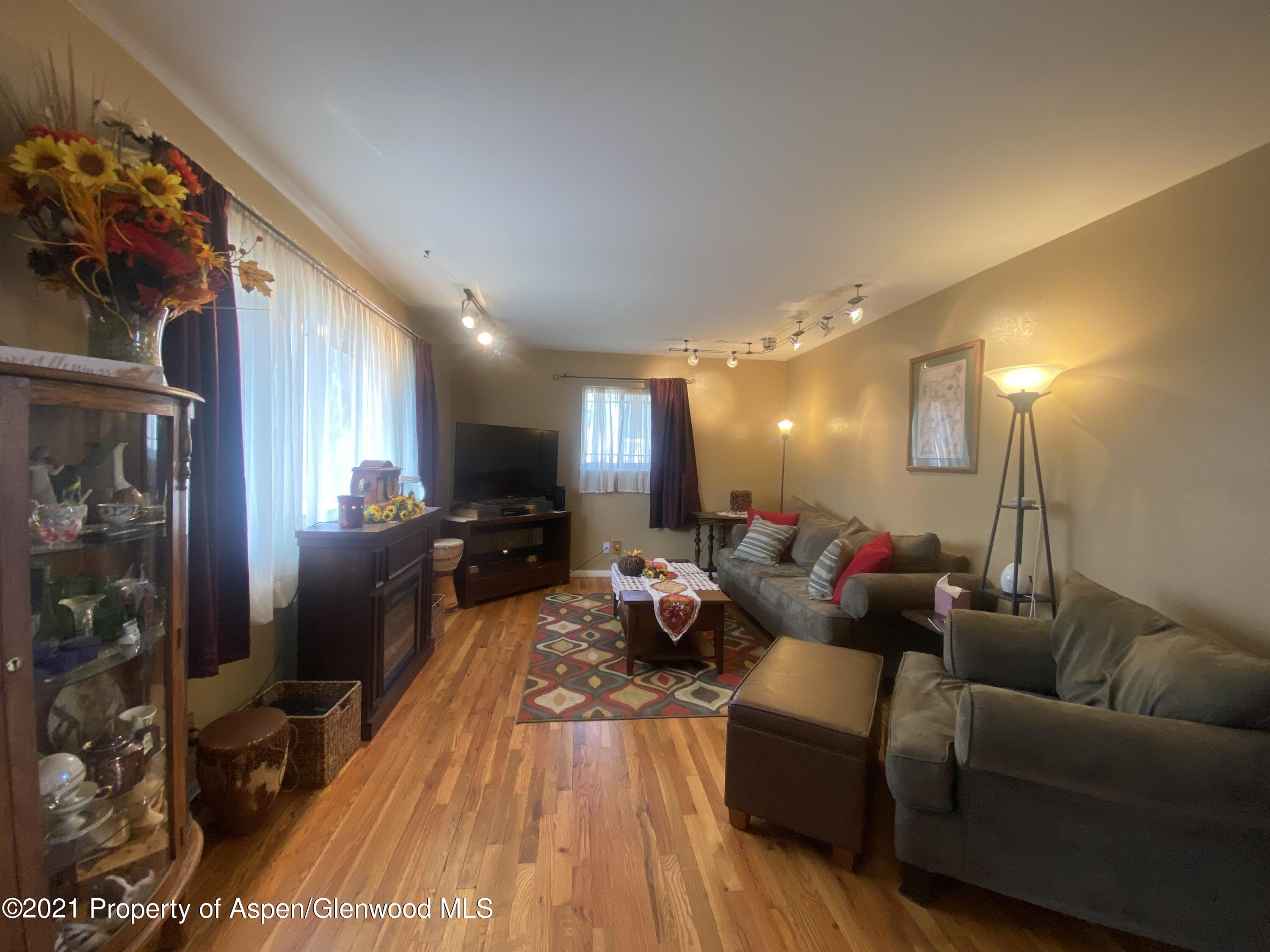 404 Hutton Avenue Rifle, CO 81650 - Photo 4 of 27 a living room with furniture and wooden floor