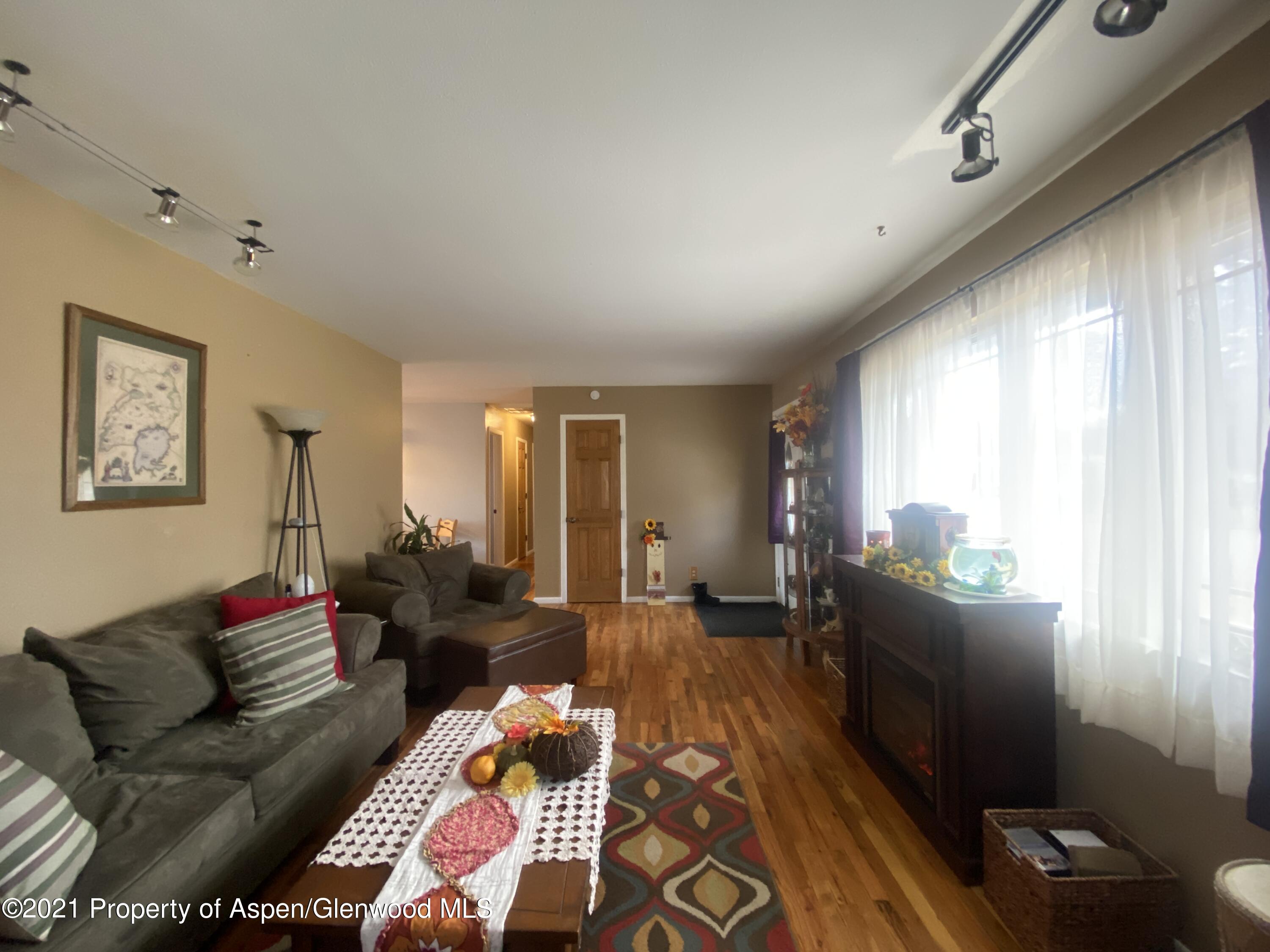 404 Hutton Avenue Rifle, CO 81650 - Photo 5 of 27 a living room with furniture and a large window