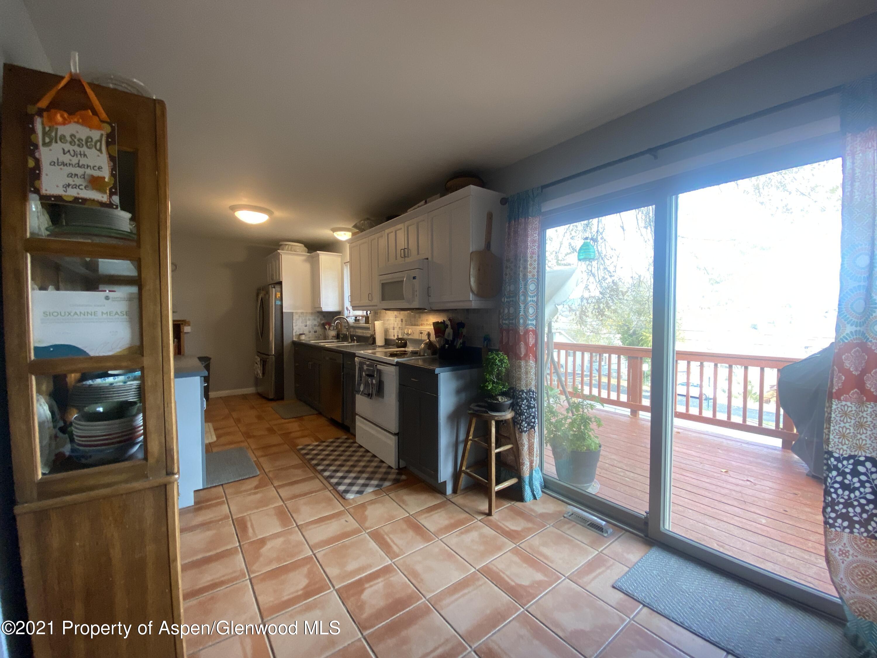 404 Hutton Avenue Rifle, CO 81650 - Photo 6 of 27 a kitchen with stainless steel appliances granite countertop a refrigerator and a sink