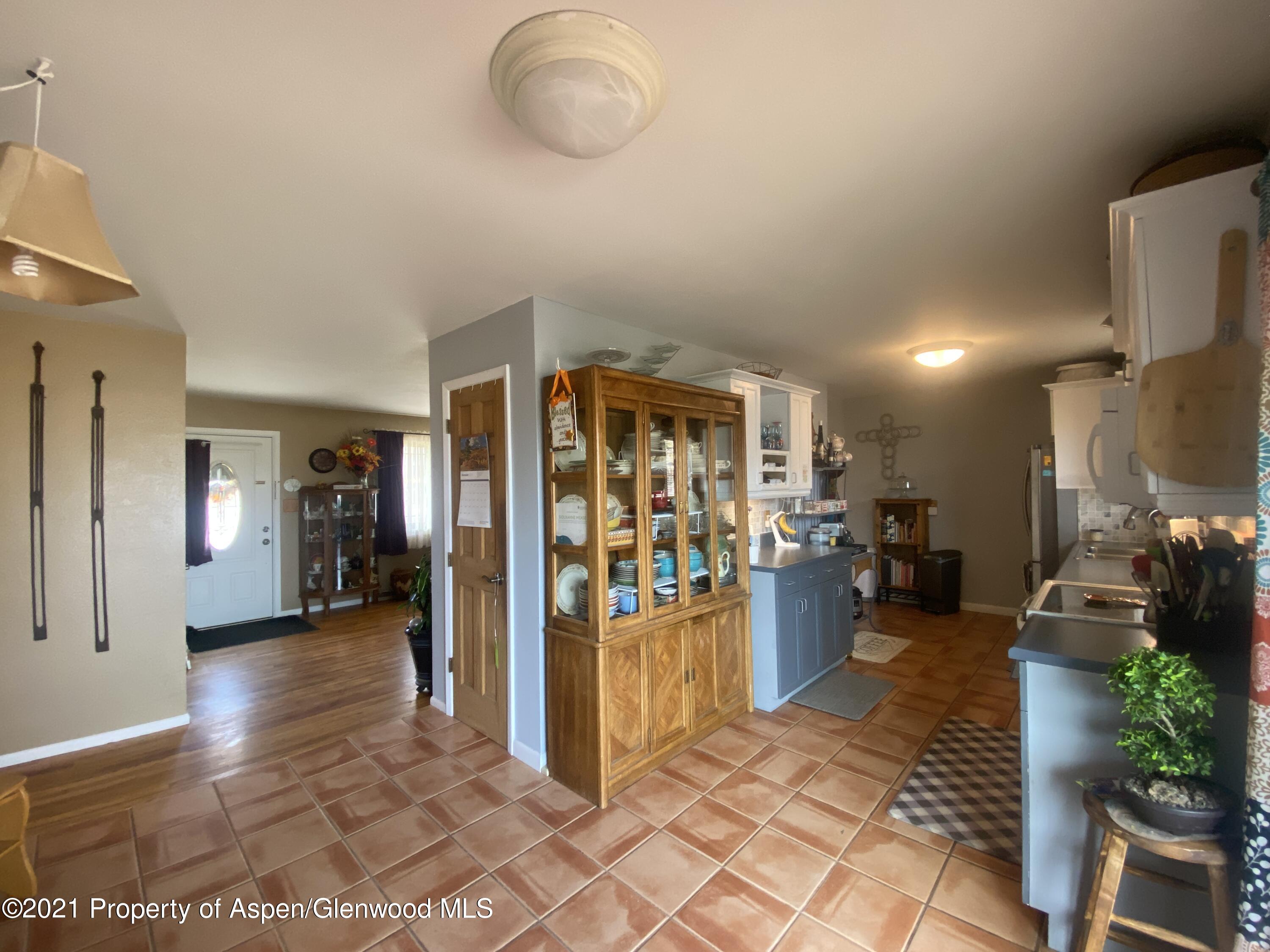 404 Hutton Avenue Rifle, CO 81650 - Photo 7 of 27 a view of a livingroom with dining area kitchen view and a refrigerator