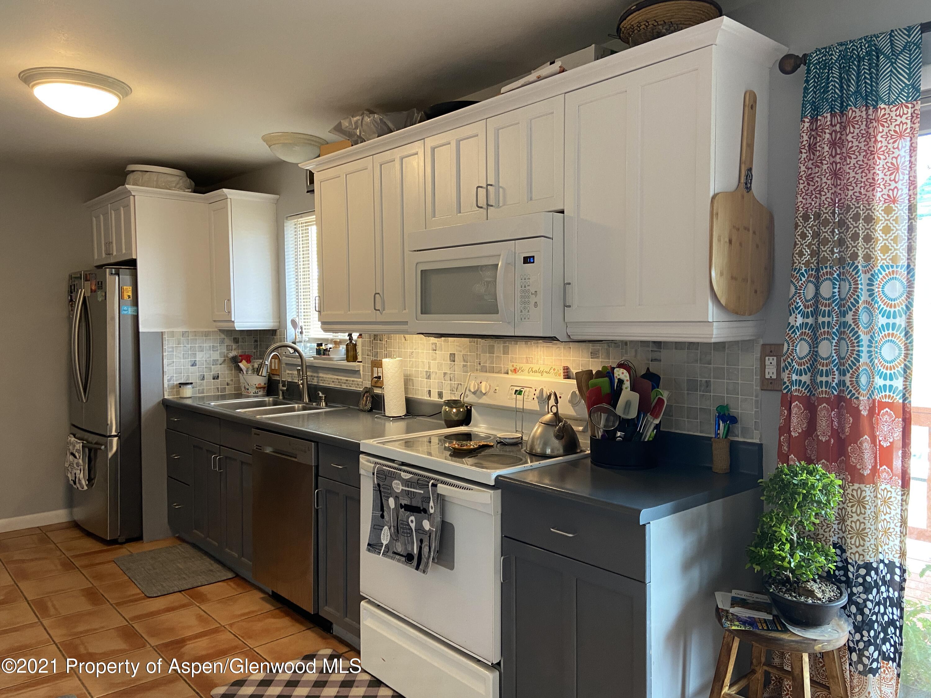404 Hutton Avenue Rifle, CO 81650 - Photo 8 of 27 a kitchen with a sink cabinets and stainless steel appliances