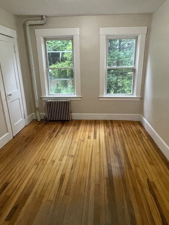 28 Carpenter Road Dudley, MA 01571 - Photo 3 of 6 a view of an empty room with wooden floor and a window