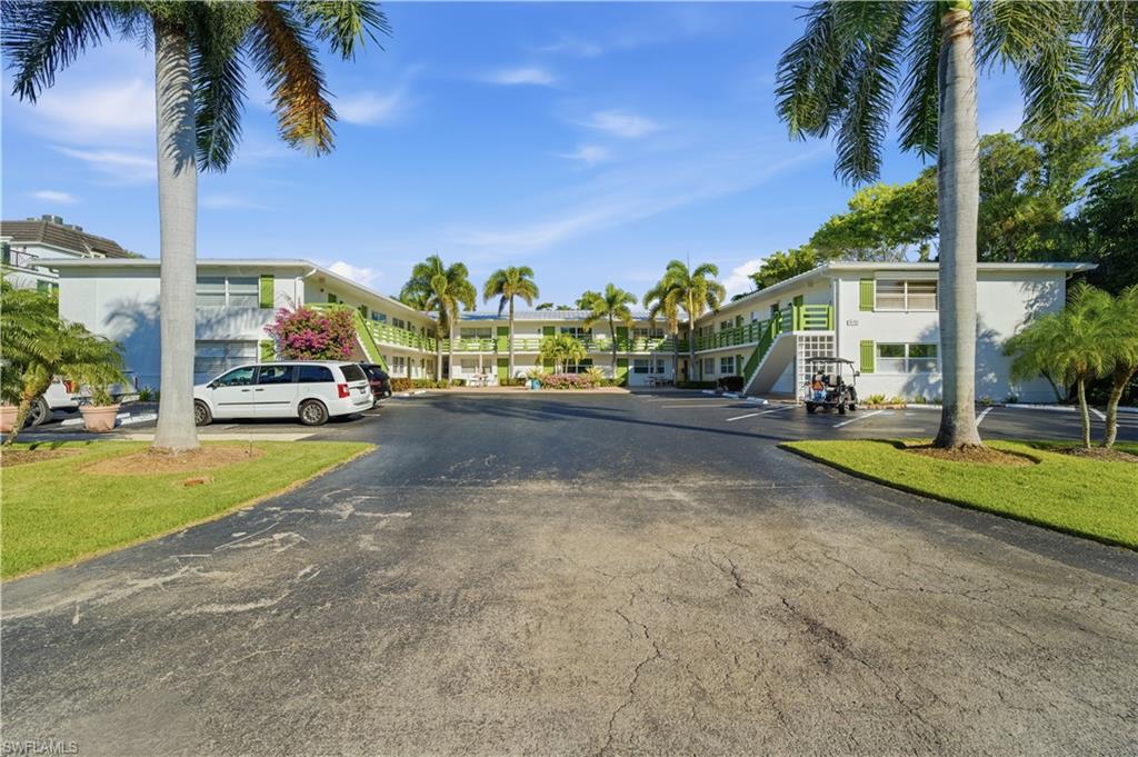 975 9th Avenue South, Unit 2 Naples, FL 34102 - Photo 13 of 18 a view of a street with a cars parked and small park