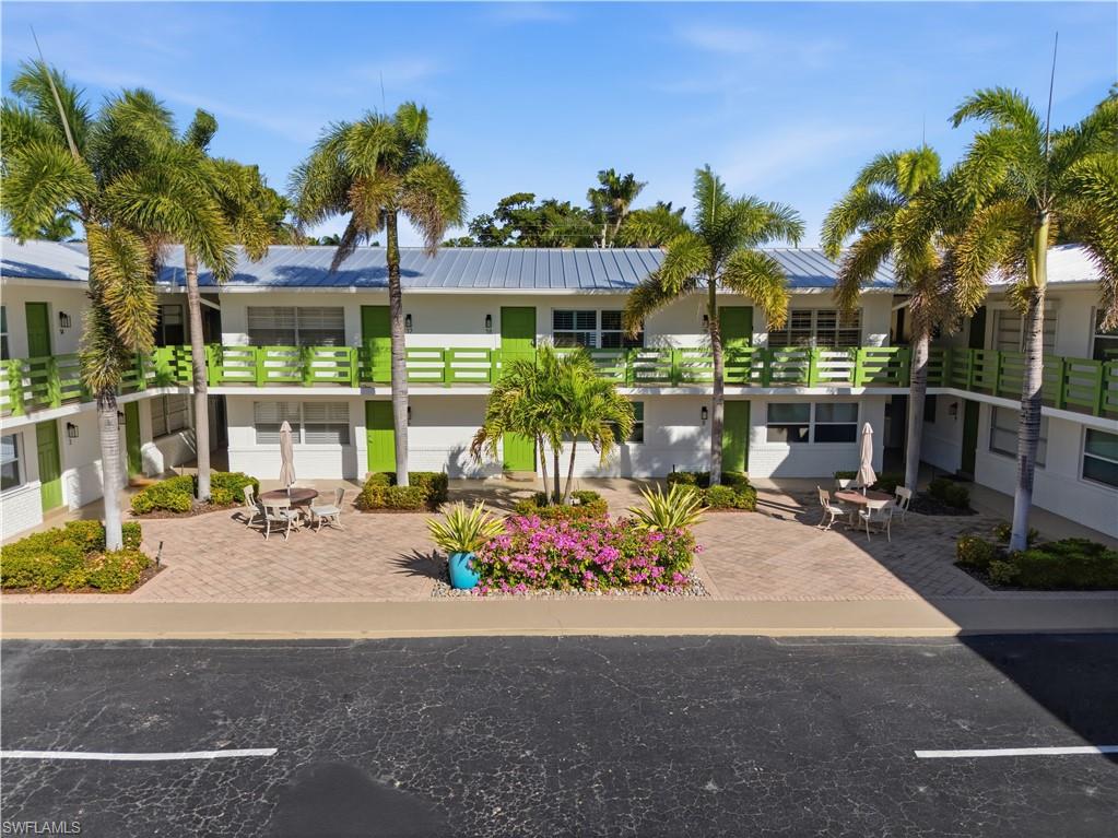 975 9th Avenue South, Unit 2 Naples, FL 34102 - Photo 15 of 18 a front view of a building with sitting area