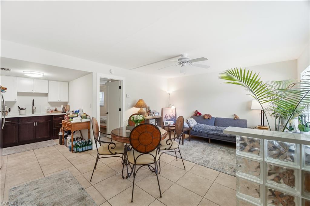 975 9th Avenue South, Unit 2 Naples, FL 34102 - Photo 5 of 18 a living room with furniture and a chandelier