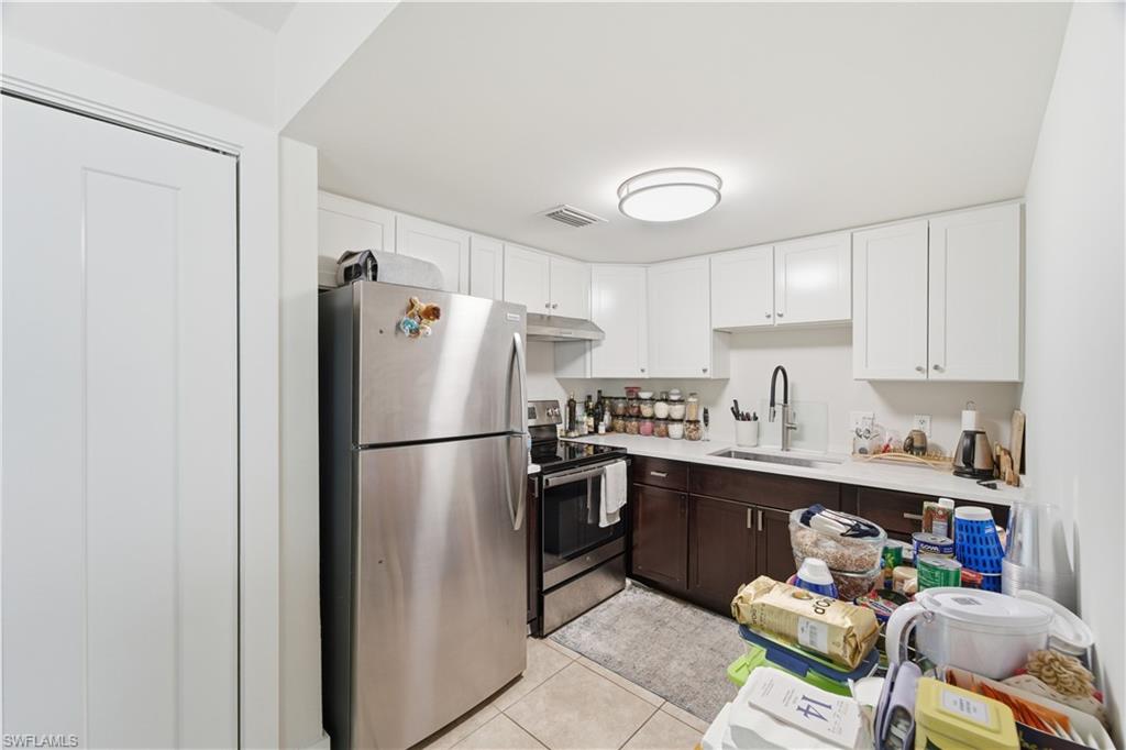 975 9th Avenue South, Unit 2 Naples, FL 34102 - Photo 9 of 18 a white refrigerator freezer sitting in a kitchen with stainless steel appliances granite countertop a refrigerator and a sink