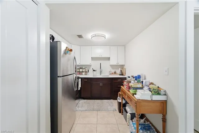 a kitchen with stainless steel appliances a sink a stove a refrigerator and cabinets