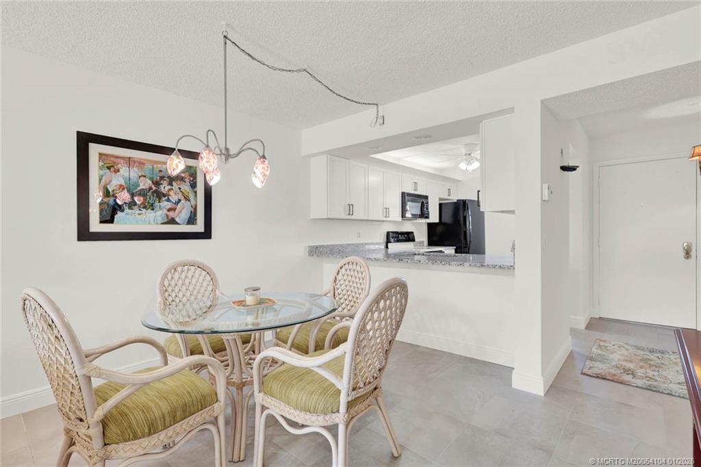 1950 Southwest Palm City Road, Unit 9102 Stuart, FL 34994 - Photo 12 of 51 a dining room with furniture and window
