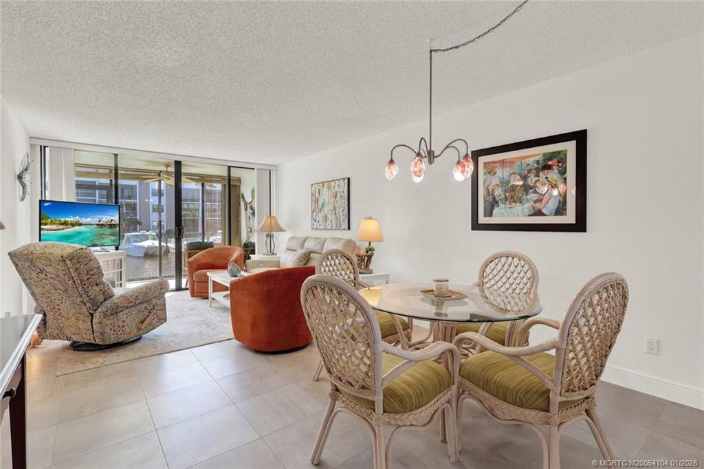 1950 Southwest Palm City Road, Unit 9102 Stuart, FL 34994 - Photo 15 of 51 a living room with furniture and a floor to ceiling window