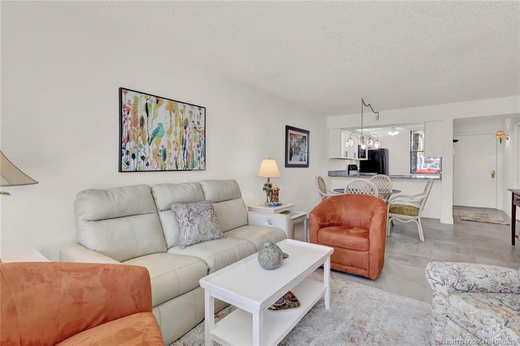 1950 Southwest Palm City Road, Unit 9102 Stuart, FL 34994 - Photo 19 of 51 a living room with furniture a couch and kitchen view