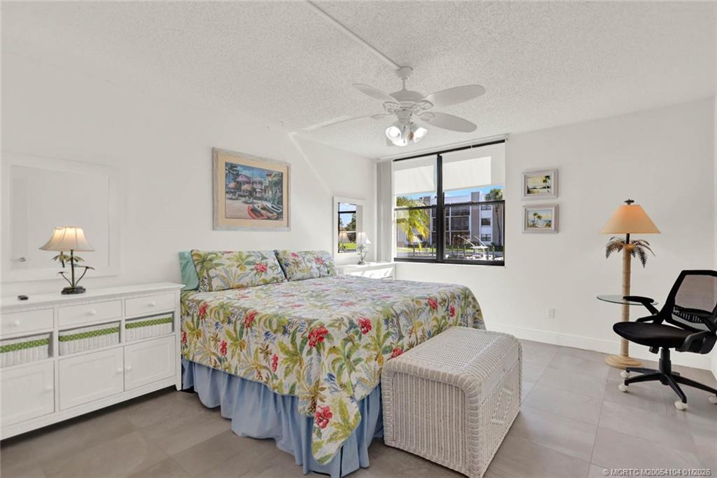 1950 Southwest Palm City Road, Unit 9102 Stuart, FL 34994 - Photo 23 of 51 a bedroom with a bed furniture and window