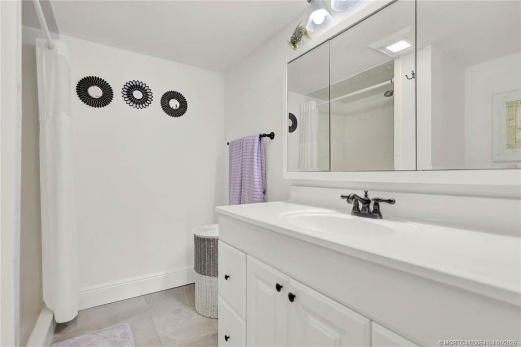 1950 Southwest Palm City Road, Unit 9102 Stuart, FL 34994 - Photo 27 of 51 a bathroom with a sink and a mirror
