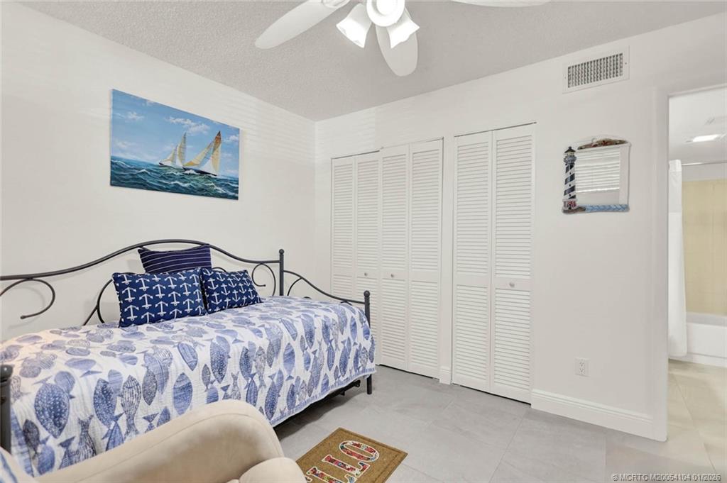 1950 Southwest Palm City Road, Unit 9102 Stuart, FL 34994 - Photo 30 of 51 a bedroom with a bed and a painting on the wall