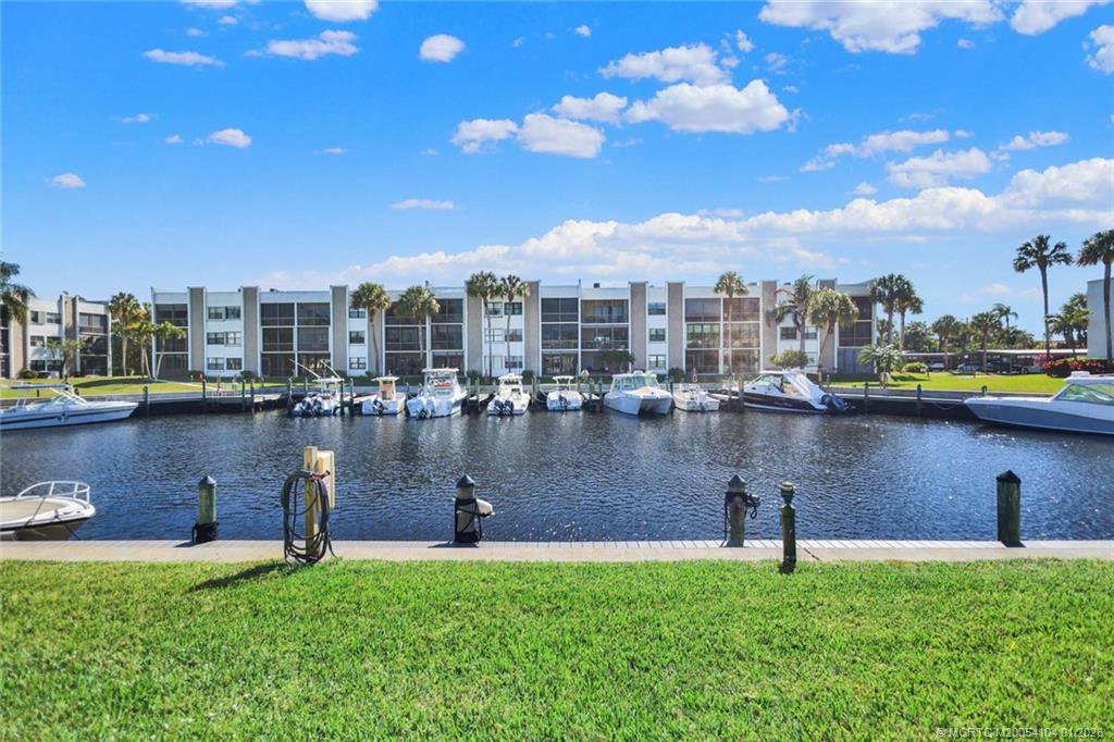1950 Southwest Palm City Road, Unit 9102 Stuart, FL 34994 - Photo 34 of 51 a view of a lake with a yard