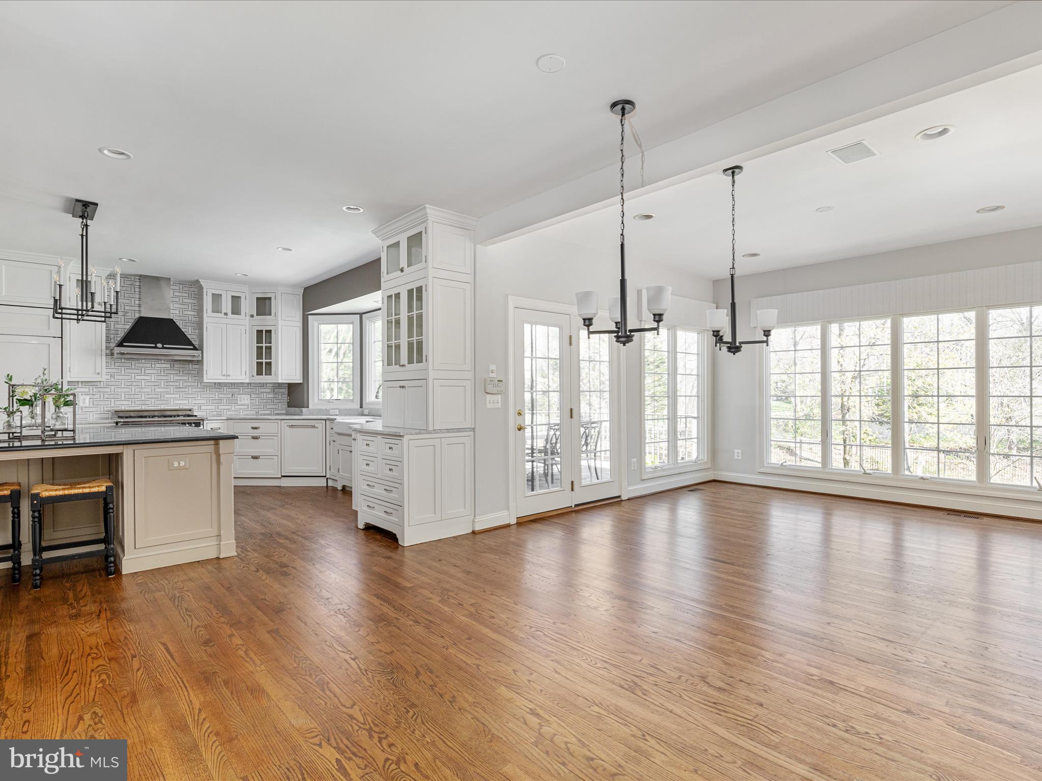 10554 Fox Forest Drive Great Falls, VA 22066 - Photo 13 of 77 a view of an empty room with a kitchen stove wooden floor and a window