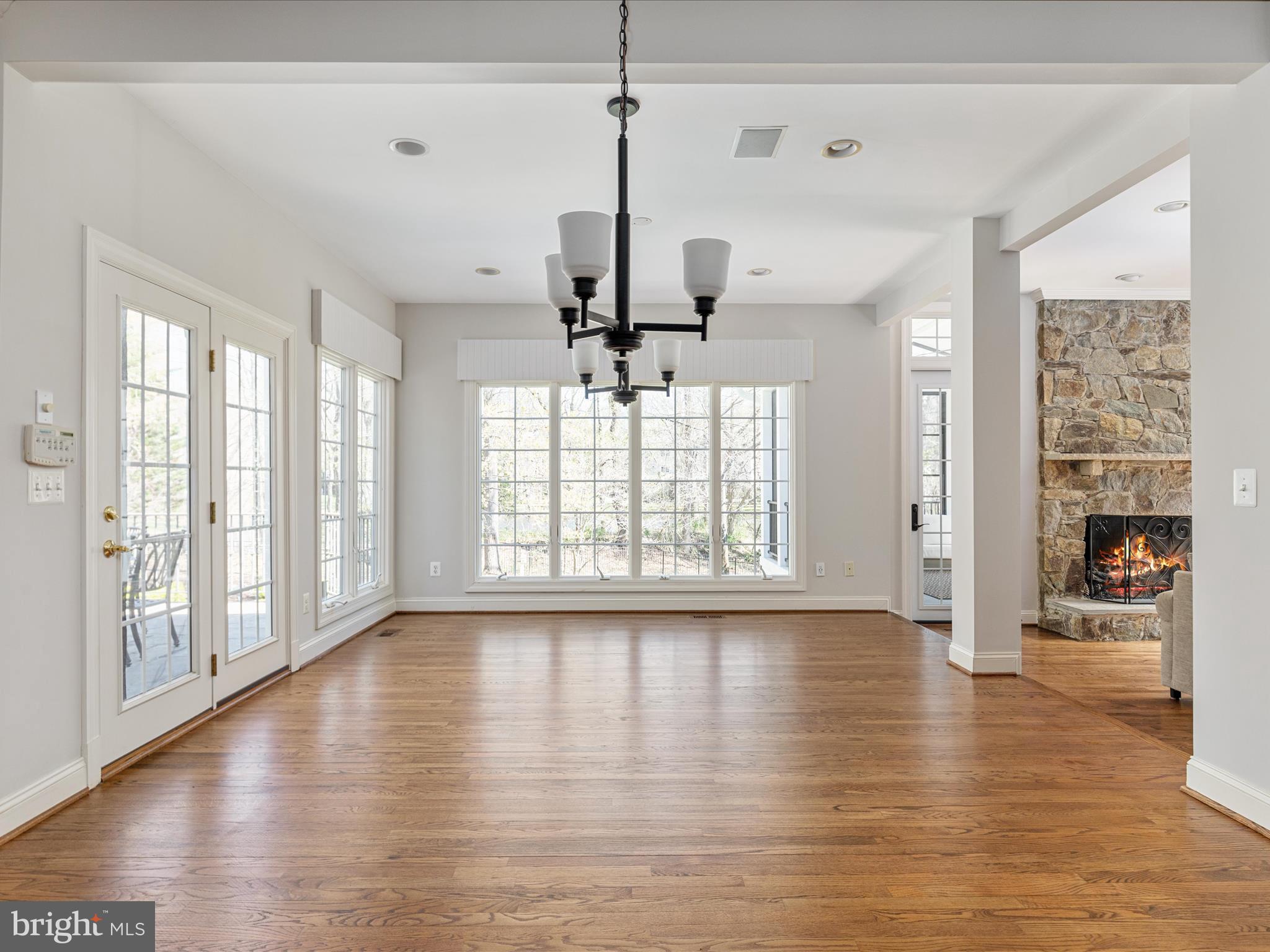10554 Fox Forest Drive Great Falls, VA 22066 - Photo 16 of 77 a view of a livingroom with wooden floor a ceiling fan and windows