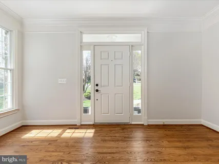 a view of room with window and wooden floor