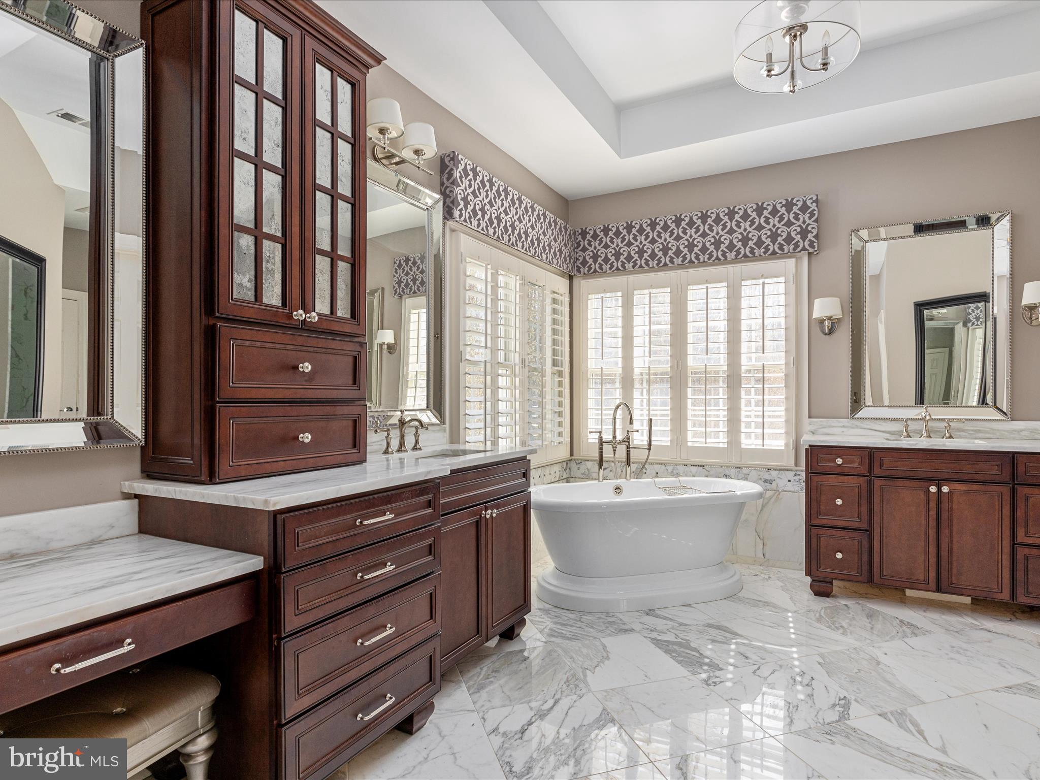 10554 Fox Forest Drive Great Falls, VA 22066 - Photo 28 of 77 a spacious bathroom with a granite countertop sink mirror and a bathtub
