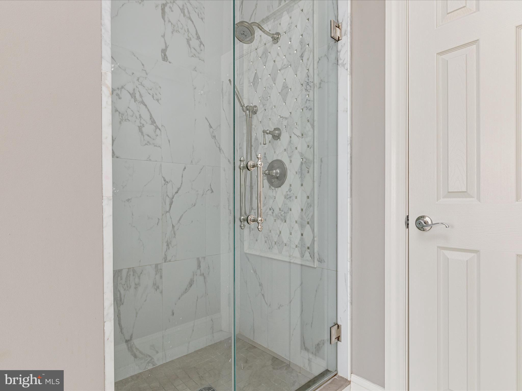 10554 Fox Forest Drive Great Falls, VA 22066 - Photo 29 of 77 a bathroom with a glass shower door