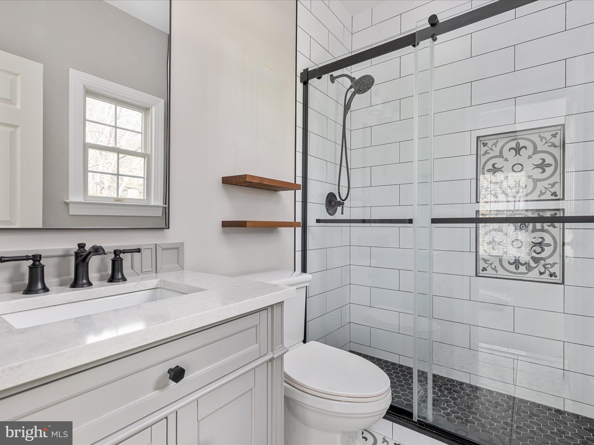 10554 Fox Forest Drive Great Falls, VA 22066 - Photo 34 of 77 a bathroom with a sink a toilet and shower