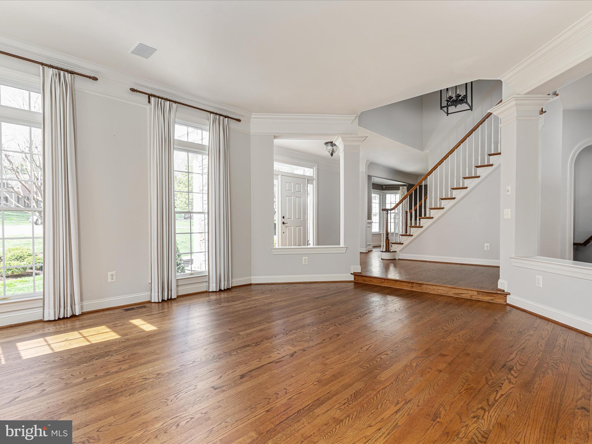 10554 Fox Forest Drive Great Falls, VA 22066 - Photo 4 of 77 a view of an empty room with wooden floor and a window