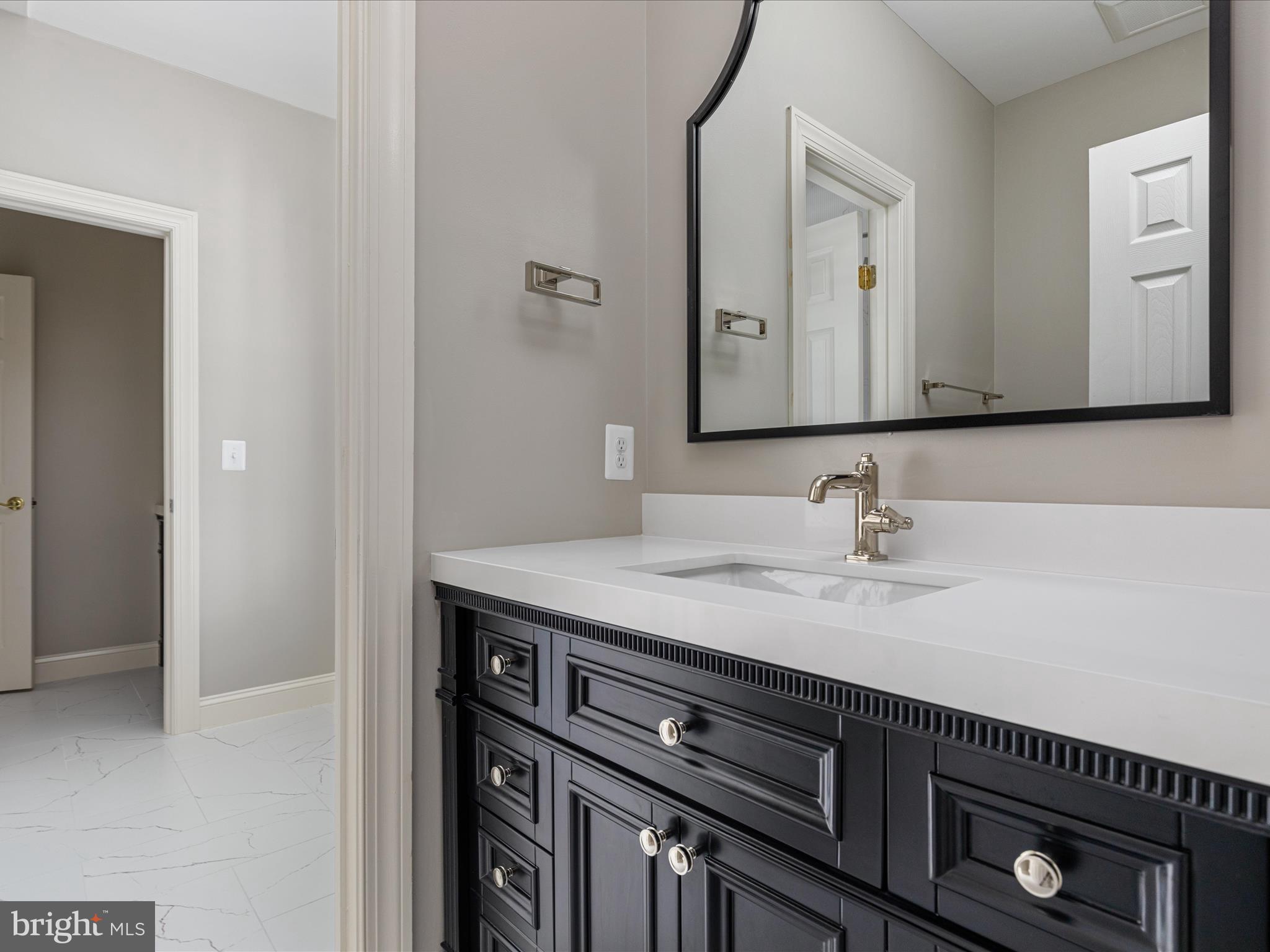 10554 Fox Forest Drive Great Falls, VA 22066 - Photo 40 of 77 a bathroom with a sink and a mirror