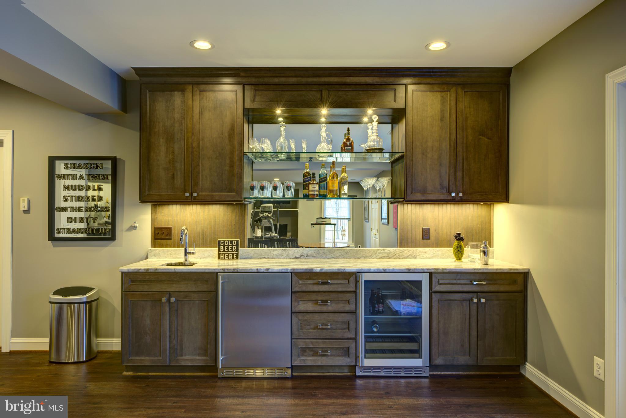10554 Fox Forest Drive Great Falls, VA 22066 - Photo 47 of 77 a kitchen with stainless steel appliances granite countertop a sink and wooden cabinets