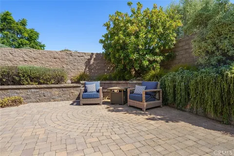 a dining room with furniture and large windows