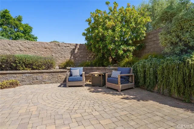 a dining room with furniture and large windows