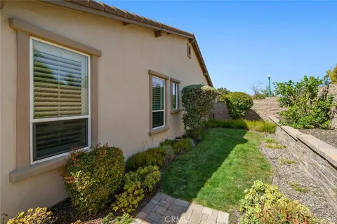 a spacious bedroom with a bed and a flat screen tv