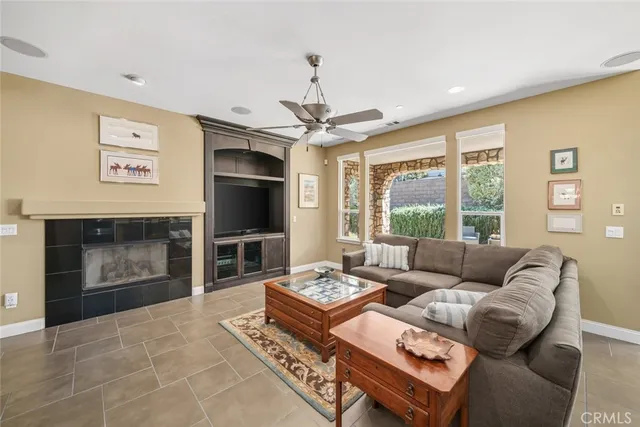 a kitchen with stainless steel appliances granite countertop a refrigerator a stove a sink a dining table and chairs