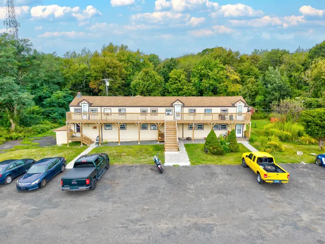 an aerial view of a house with a backyard and a patio