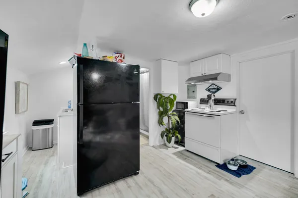 a kitchen with a refrigerator and a stove