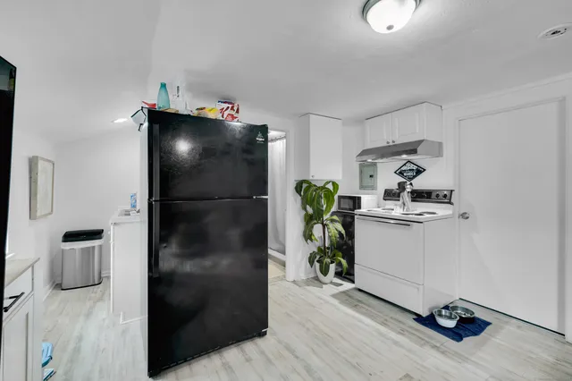 a kitchen with a refrigerator and a stove