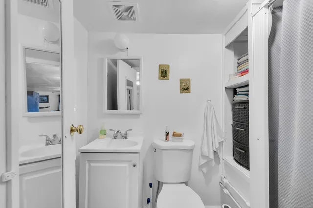 a bathroom with a sink toilet and vanity