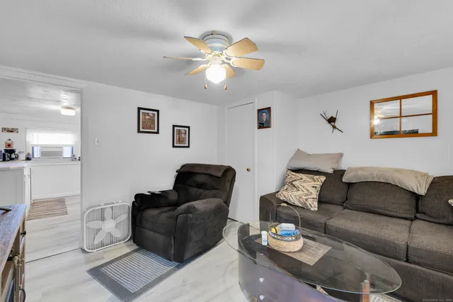 a living room with furniture and a ceiling fan