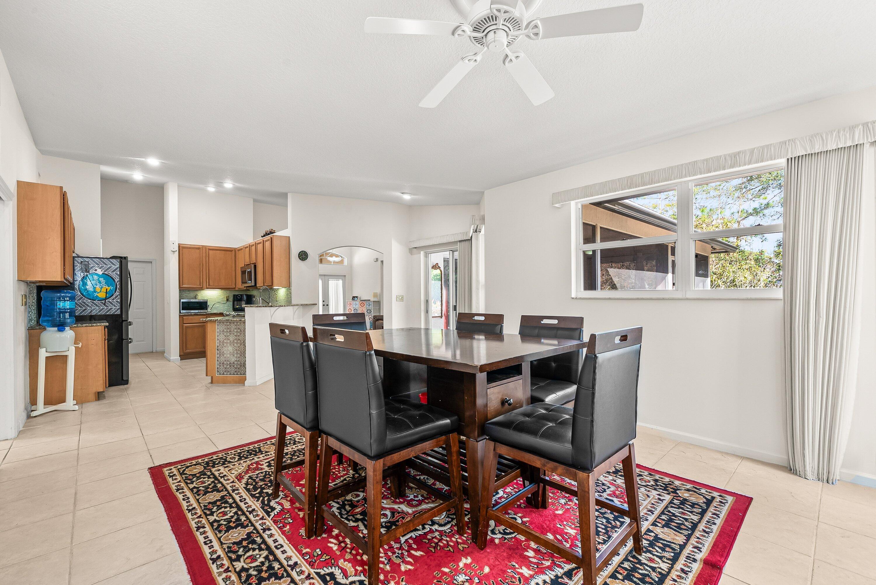 18098 93rd Road North The Acreage, FL 33470 - Photo 12 of 60 a view of a dining room with furniture